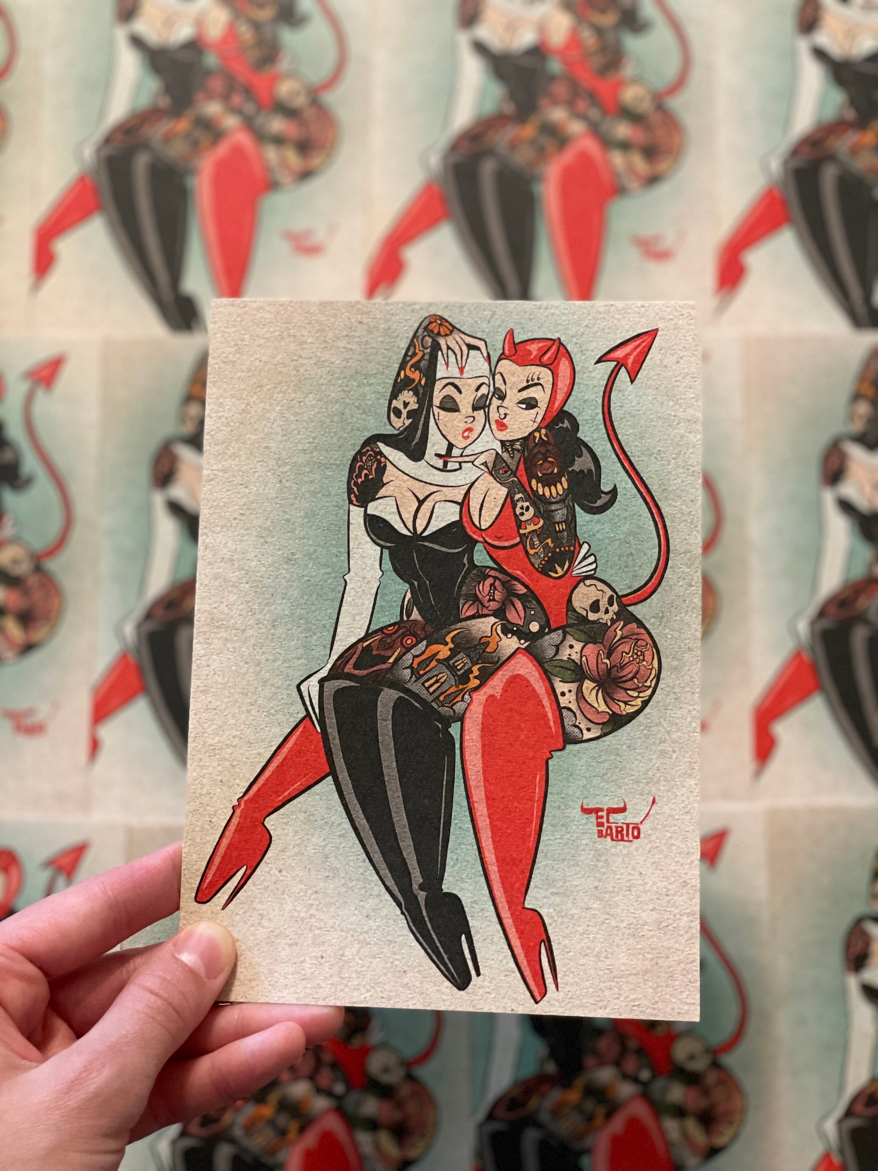 hand holding 5x7 inch wicked ladies print of tattooed devil and nun by bloodknotcollective