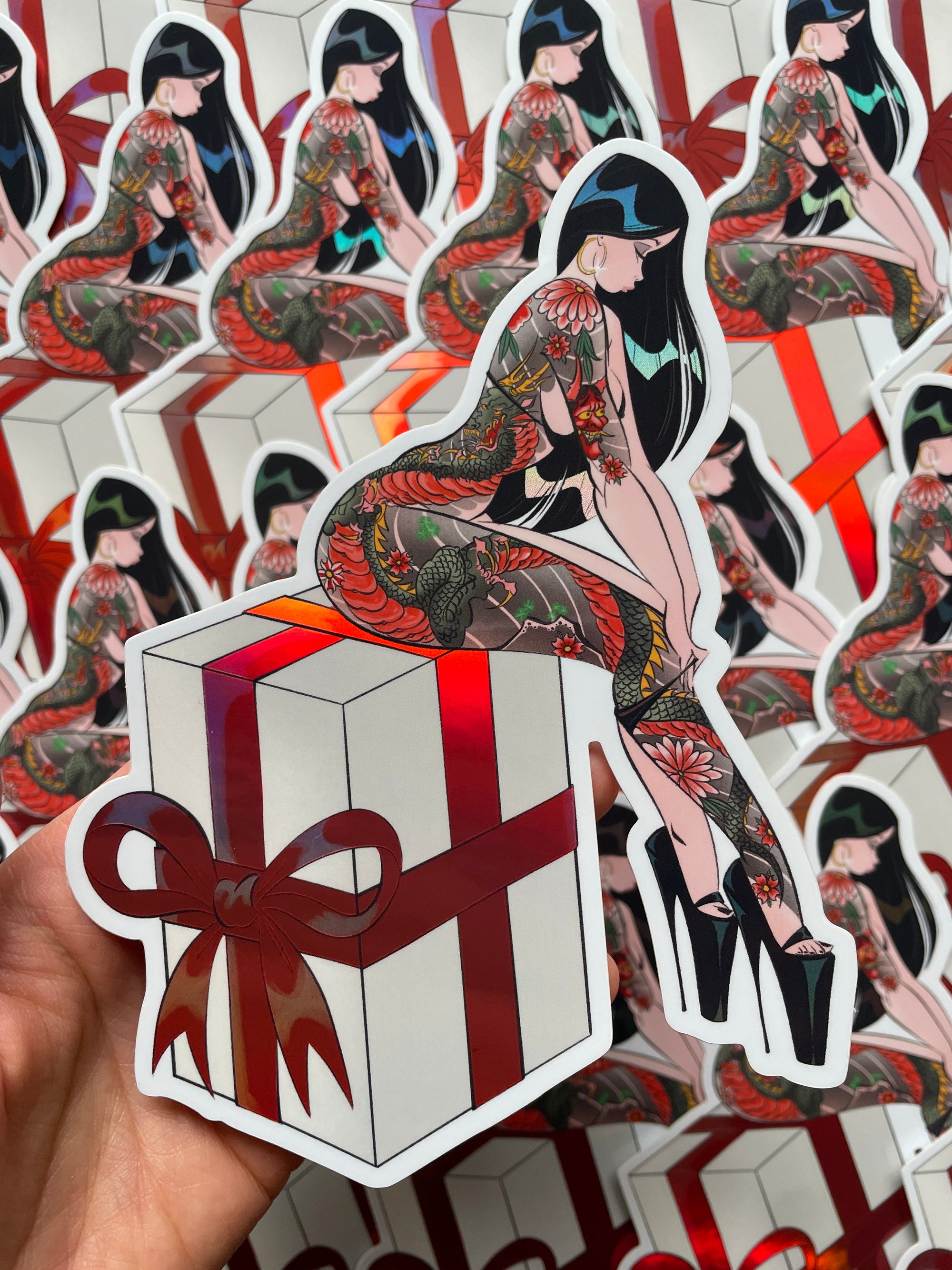 woman with japanese tattoos sitting on large present holographic jumbo vinyl sticker by bloodknotcollective
