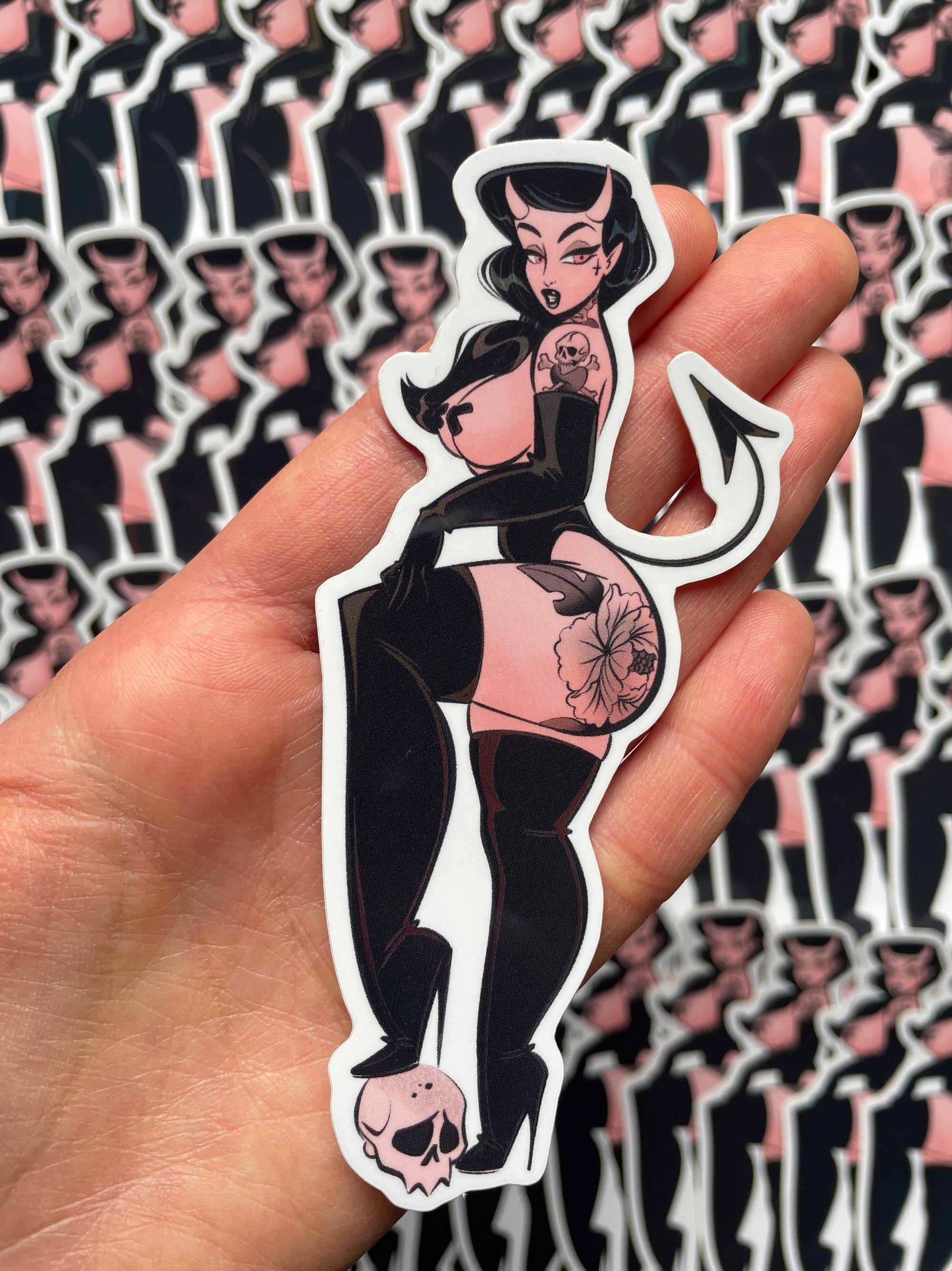 lil devil with tattoos standing on skull holographic sticker by bloodknotcollective