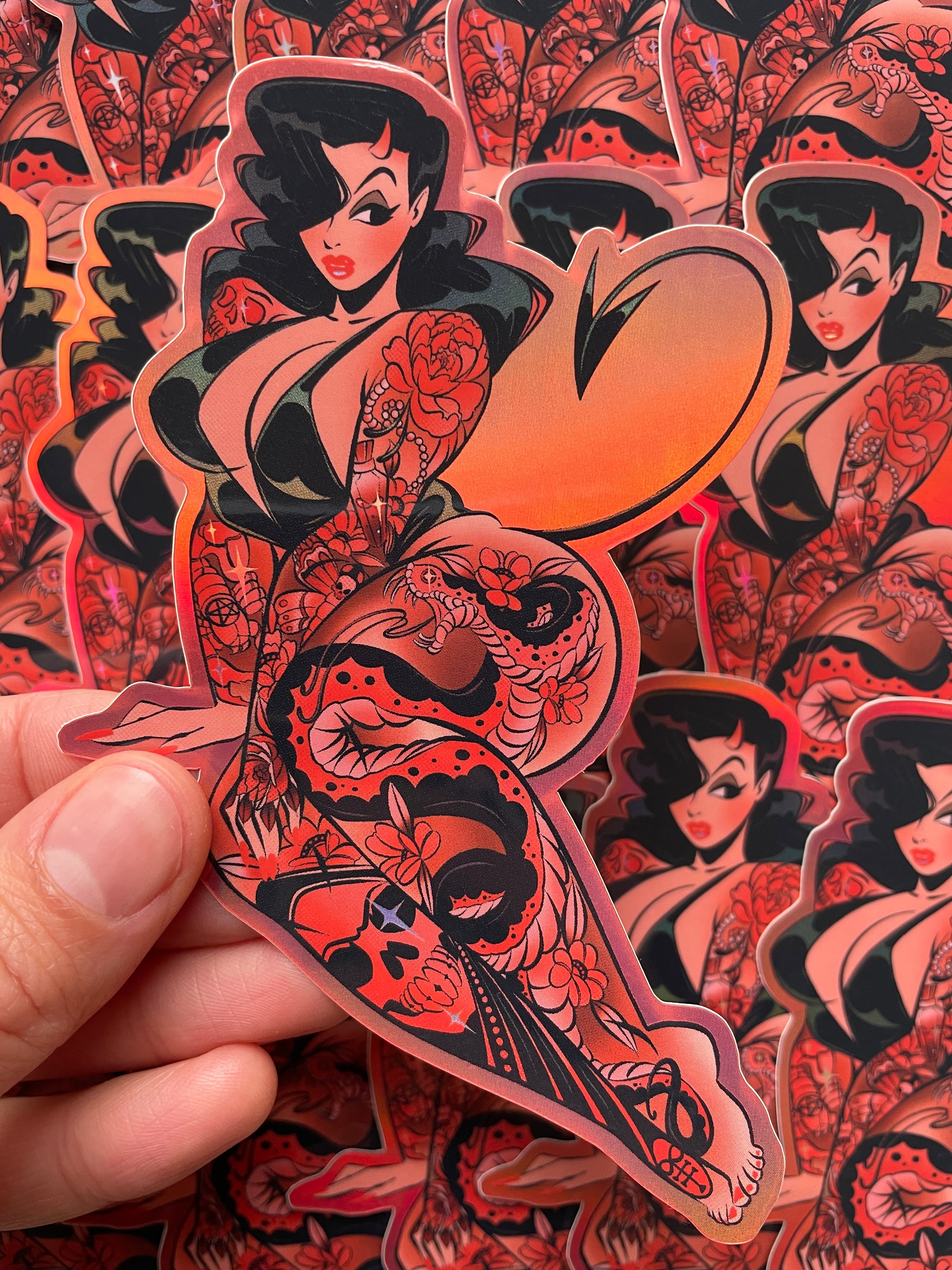 red devil with tattoos holographic vinyl sticker by bloodknotcollective