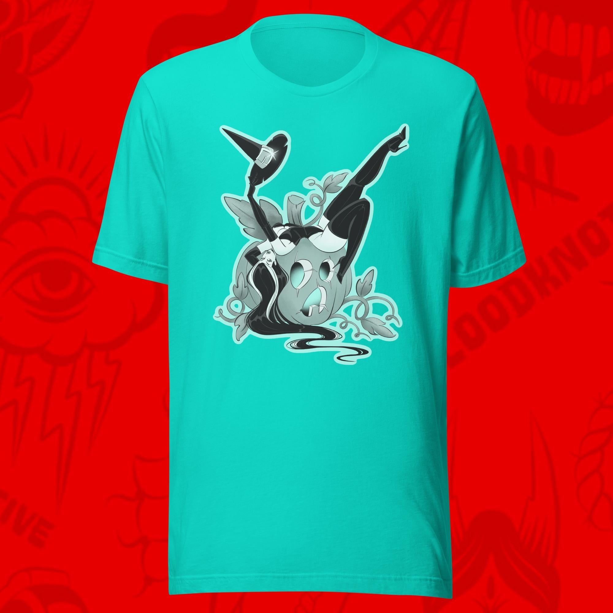 season of the witch of woman leaning over pumpkin on teal tee by bloodknotcollective