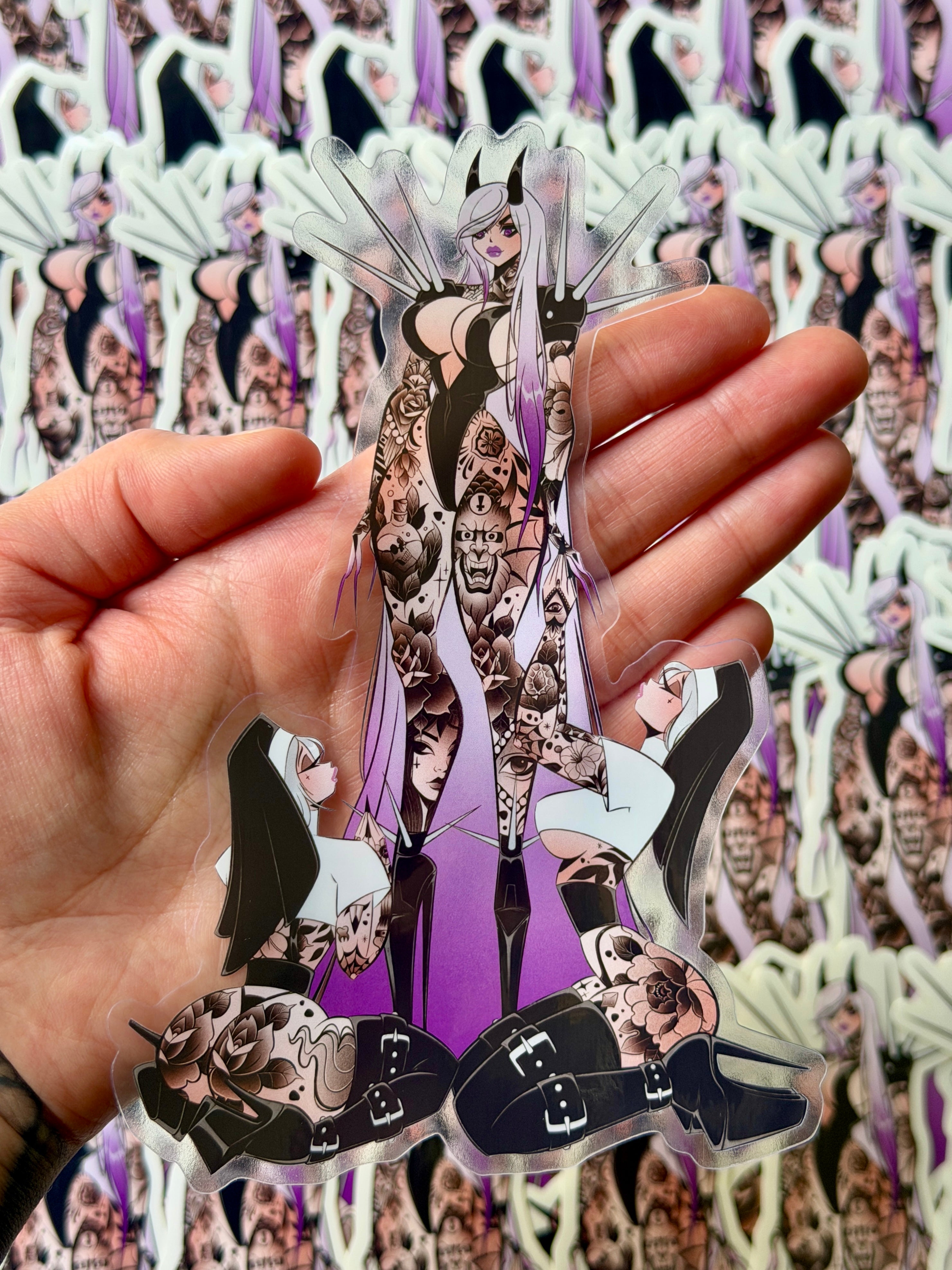 die cut clear vinyl sticker of tattooed devil pinup and tattooed nuns by bloodknotcollective. 