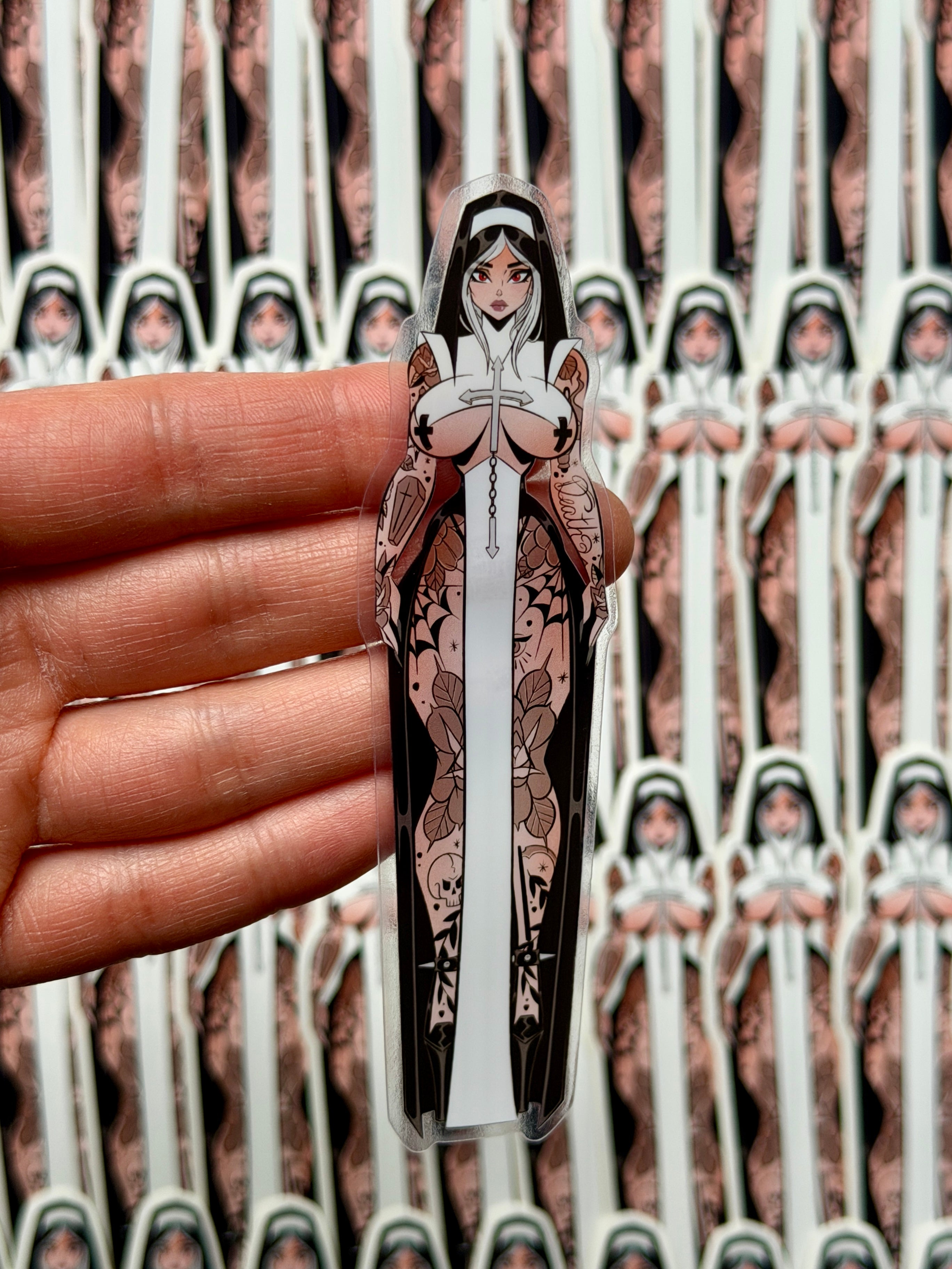 One clear vinyl die cut sticker of a gothic tattooed nun. 